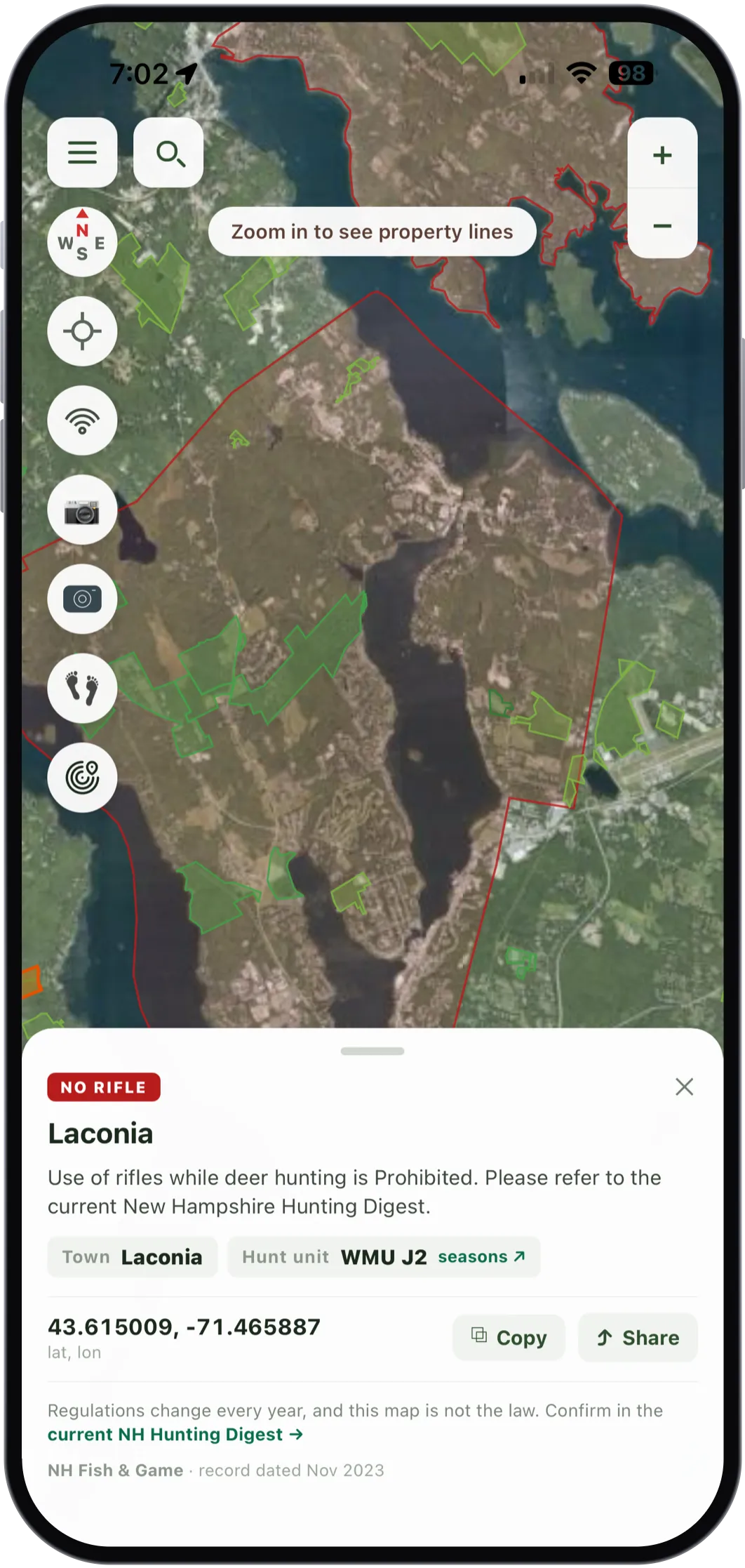 The card for a weapon restriction in Laconia, the area outlined in red on aerial imagery. It reads NO RIFLE, Laconia, use of rifles while deer hunting is prohibited, please refer to the current New Hampshire Hunting Digest, town Laconia, hunt unit WMU J2, coordinates 43.615009 and -71.465887, and a note that regulations change every year and this map is not the law. NH Fish and Game, record dated November 2023.
